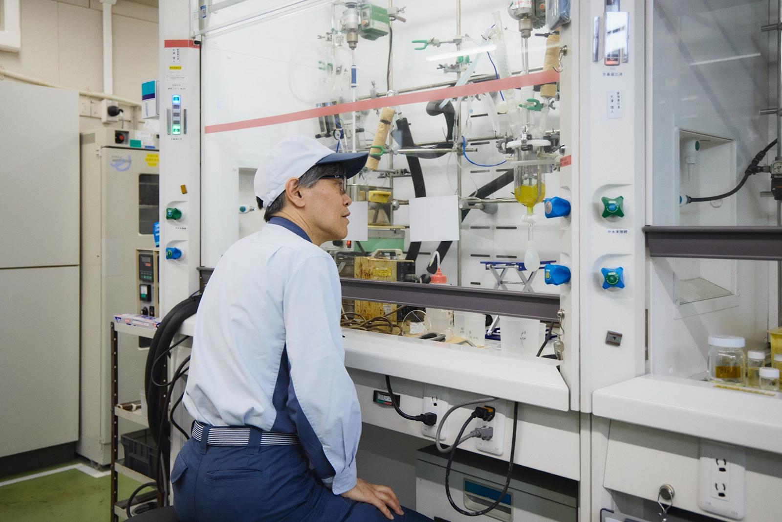 Inspecting material samples in front of laboratory equipment